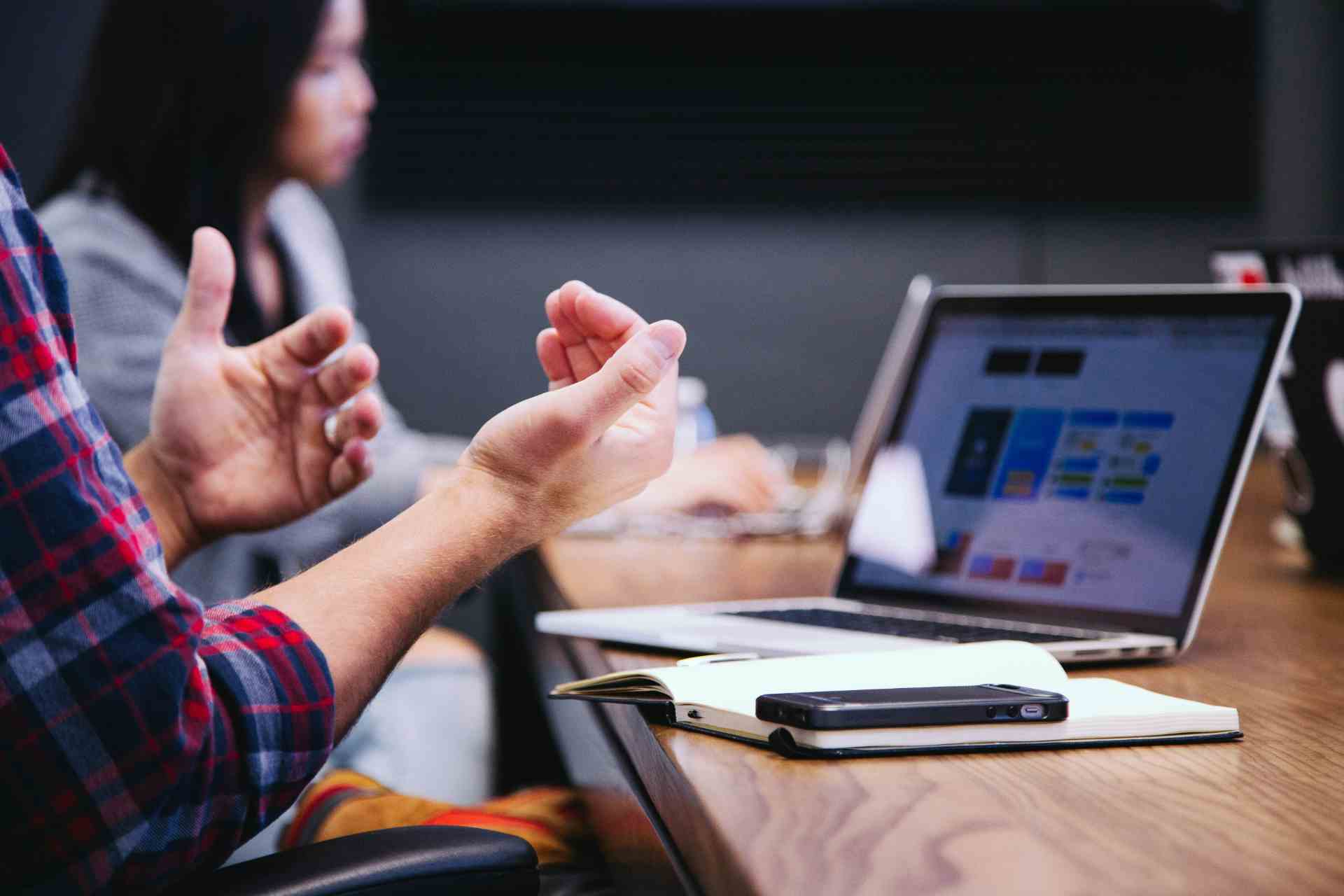 Person gesturing in a meeting