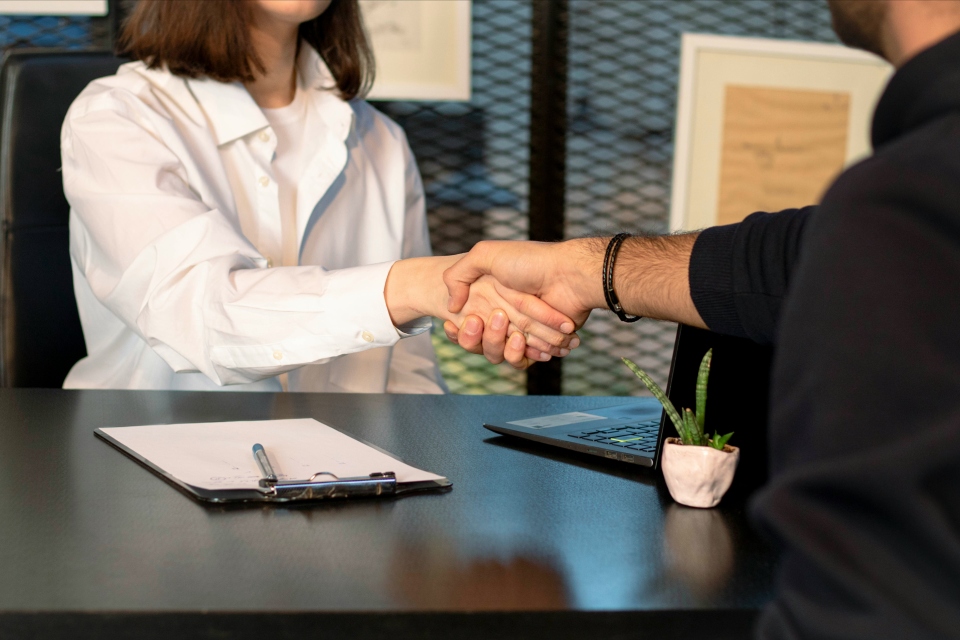 Handshake at a meeting table